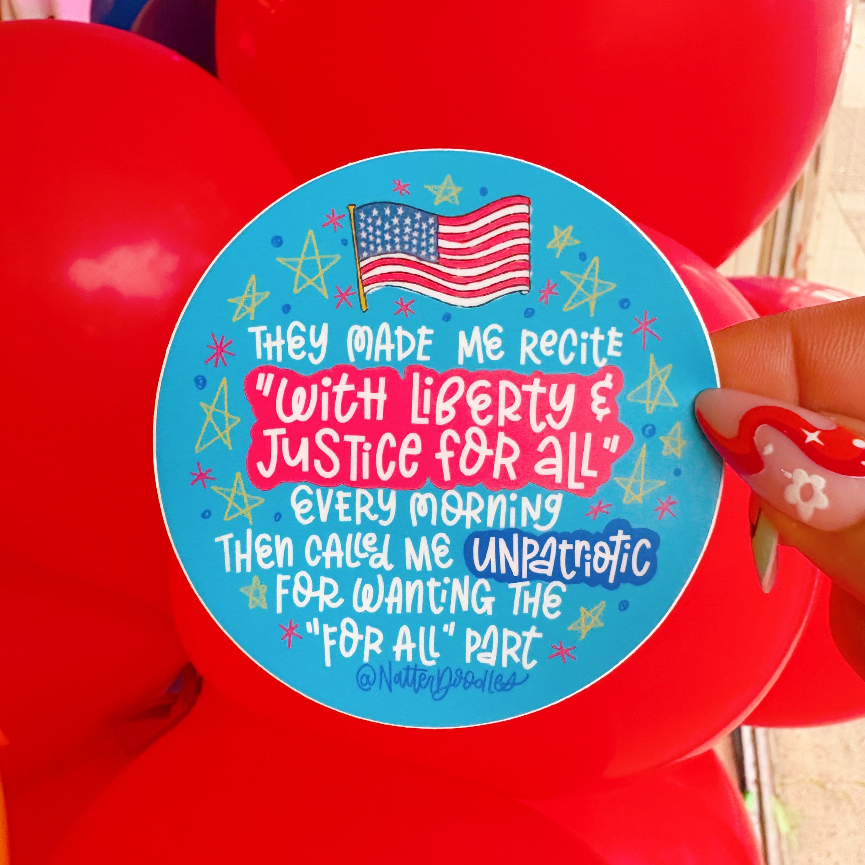 Round blue sticker with text and American flag held over red balloons