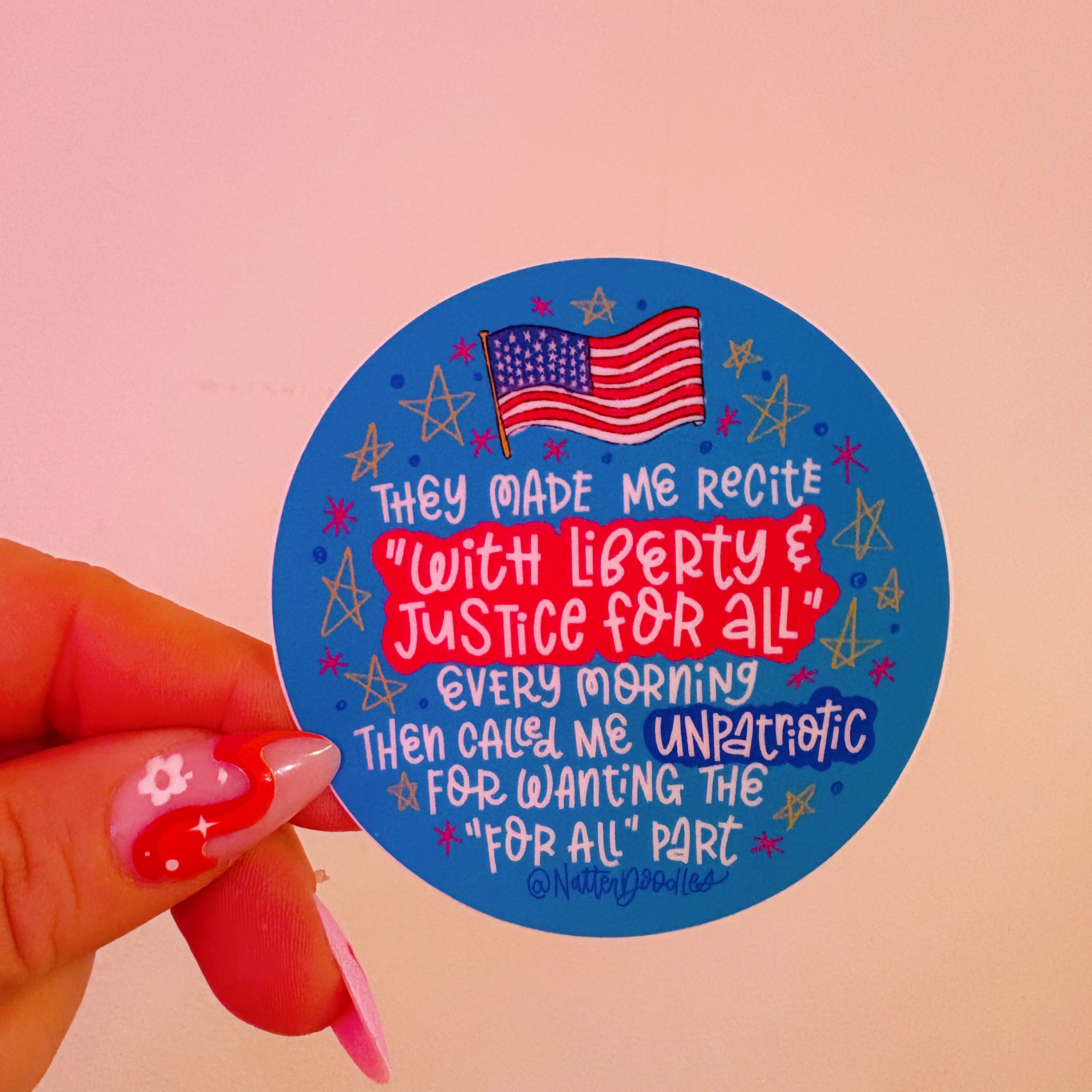 Sticker with text and American flag held by a hand on a pink background