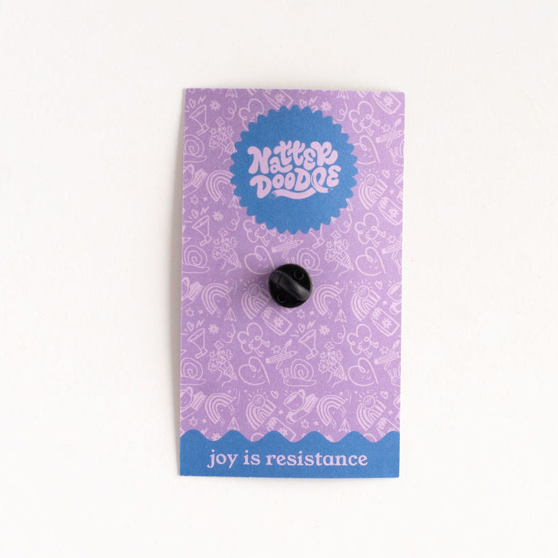 Back of the Coffee Cult acrylic pin showing secure rubber clutch backing