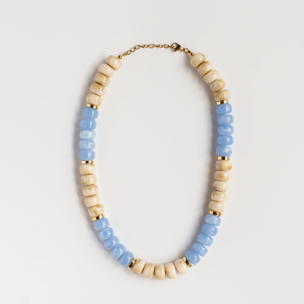 Blue Skies and Buttercream acrylic beaded necklace by NatterDoodle, front view on a white background