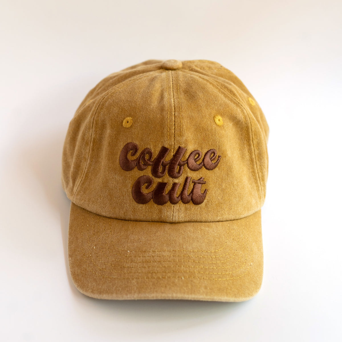 Coffee Cult mustard washed cotton dad cap with chocolate brown embroidered retro lettering, front view