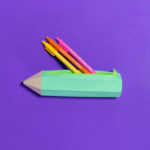 Green pencil-shaped zipper pouch with colorful pencils on a purple background