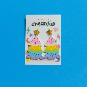Colorful star-shaped earrings on a 'chearful' branded card against a blue background
