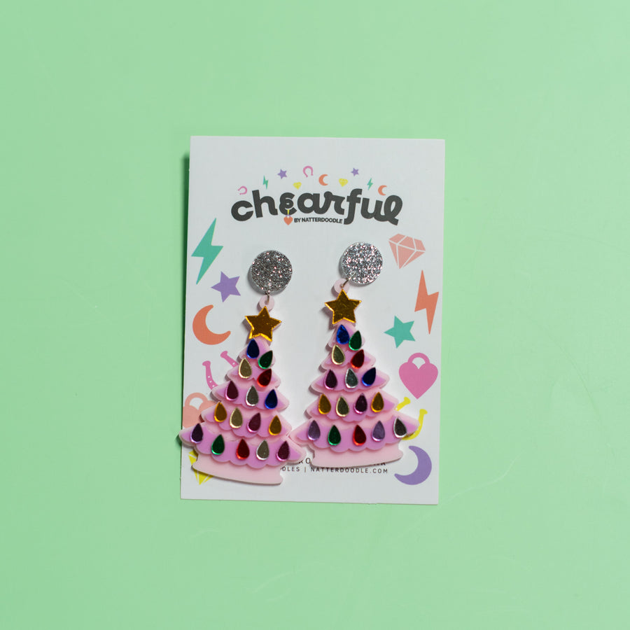 Two packages of 'cheerful' earrings on a green background