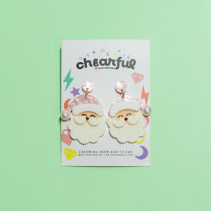 Packaged earrings with Santa Claus design on a green background