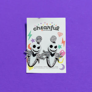 Pair of earrings with a 'cheerful' label on a purple background