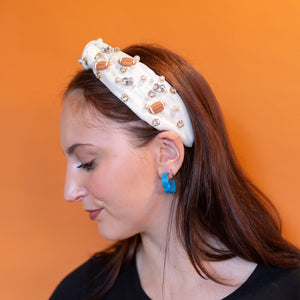 Woman wearing a decorative headband against an orange background