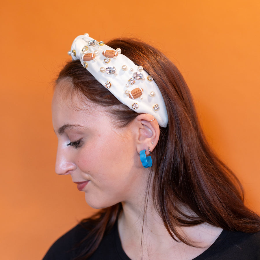 Woman wearing a decorative headband with a plain background