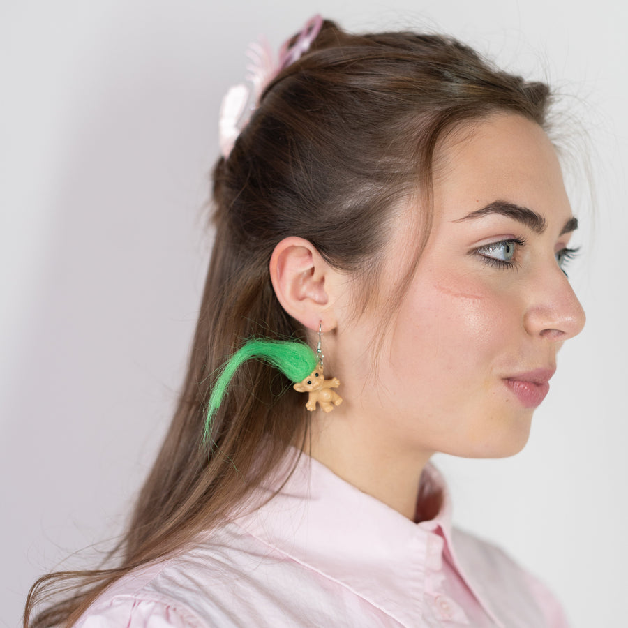 Pair of bear-shaped earrings on a 'cheerful' branded card against a bright green background