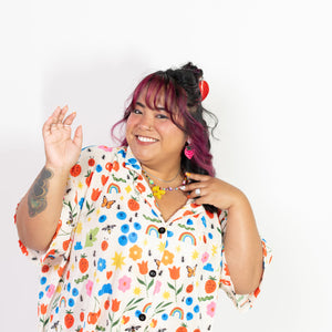 Person wearing a colorful patterned shirt against a white background