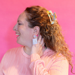 Woman wearing a pink sweater against a pink background