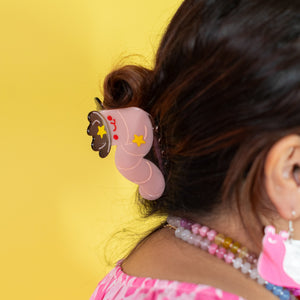 Person with a decorative hair clip on a yellow background