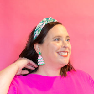 Woman wearing a bright pink top against a pink background