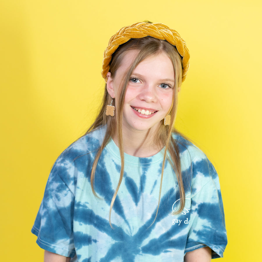 Person wearing a yellow headband against a yellow background