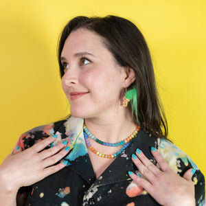 Woman wearing a colorful shirt with a yellow background