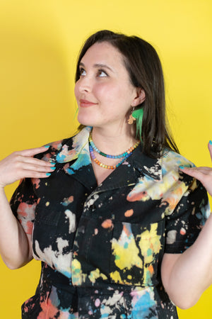 Woman wearing a colorful shirt with a yellow background