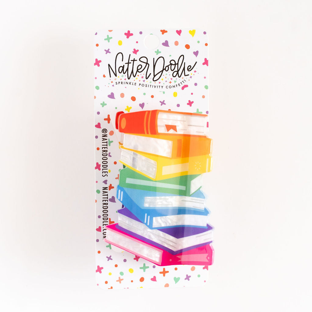 Stack of books with colorful design and 'Natter Dollie' branding on a white background