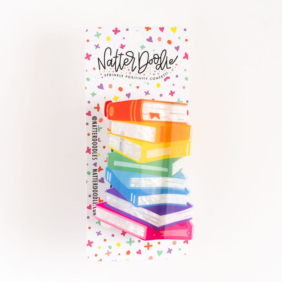 Stack of books with colorful design and 'Natter Dollie' branding on a white background