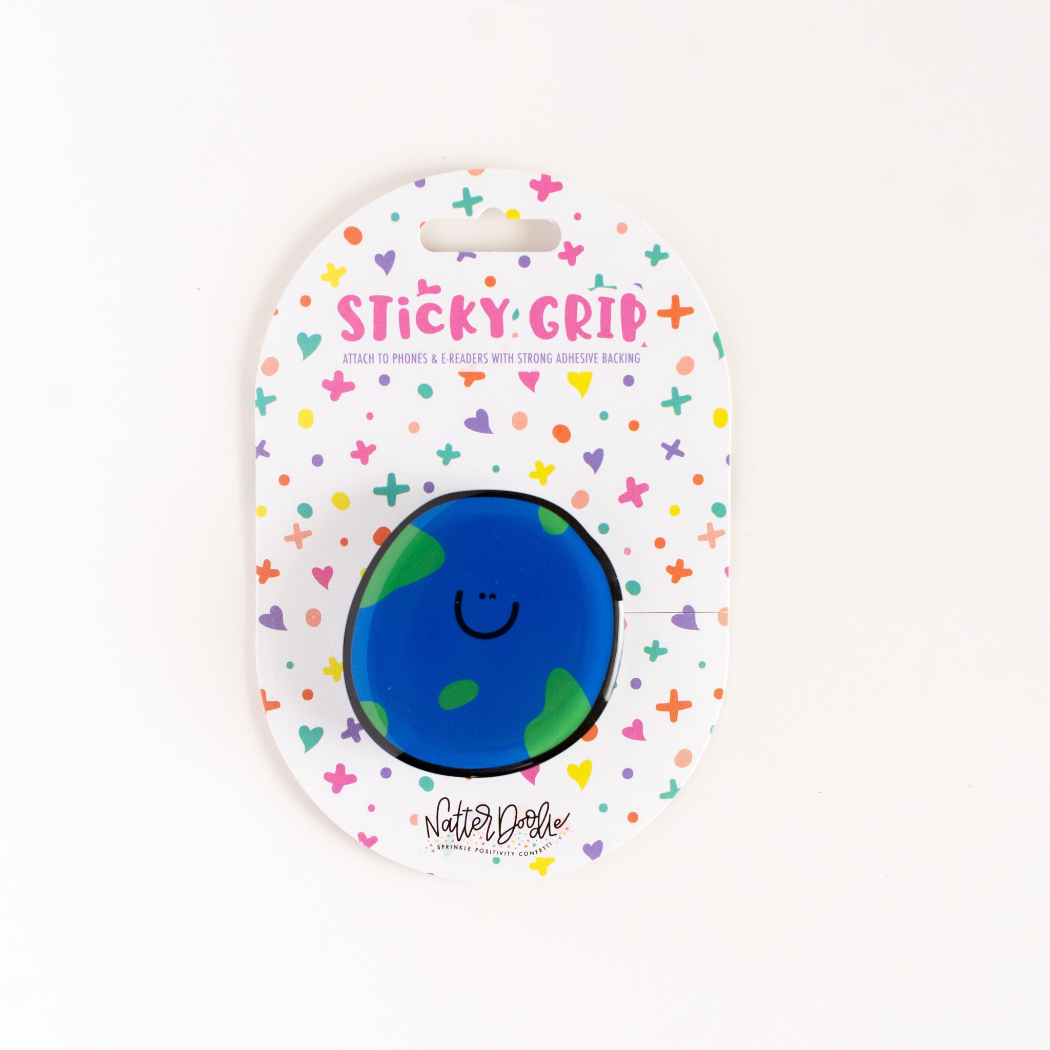 Blue round object with a smiley face on a colorful 'Sticky Grip' packaging.