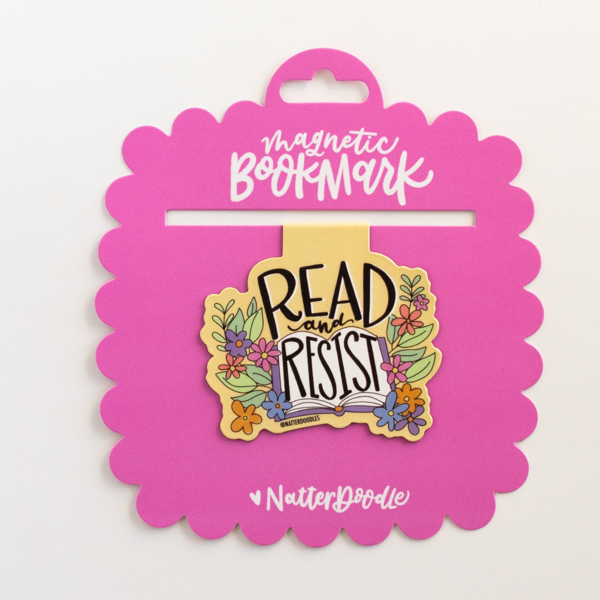 Bookmark with 'Read Resist' text on a pink card against a white background