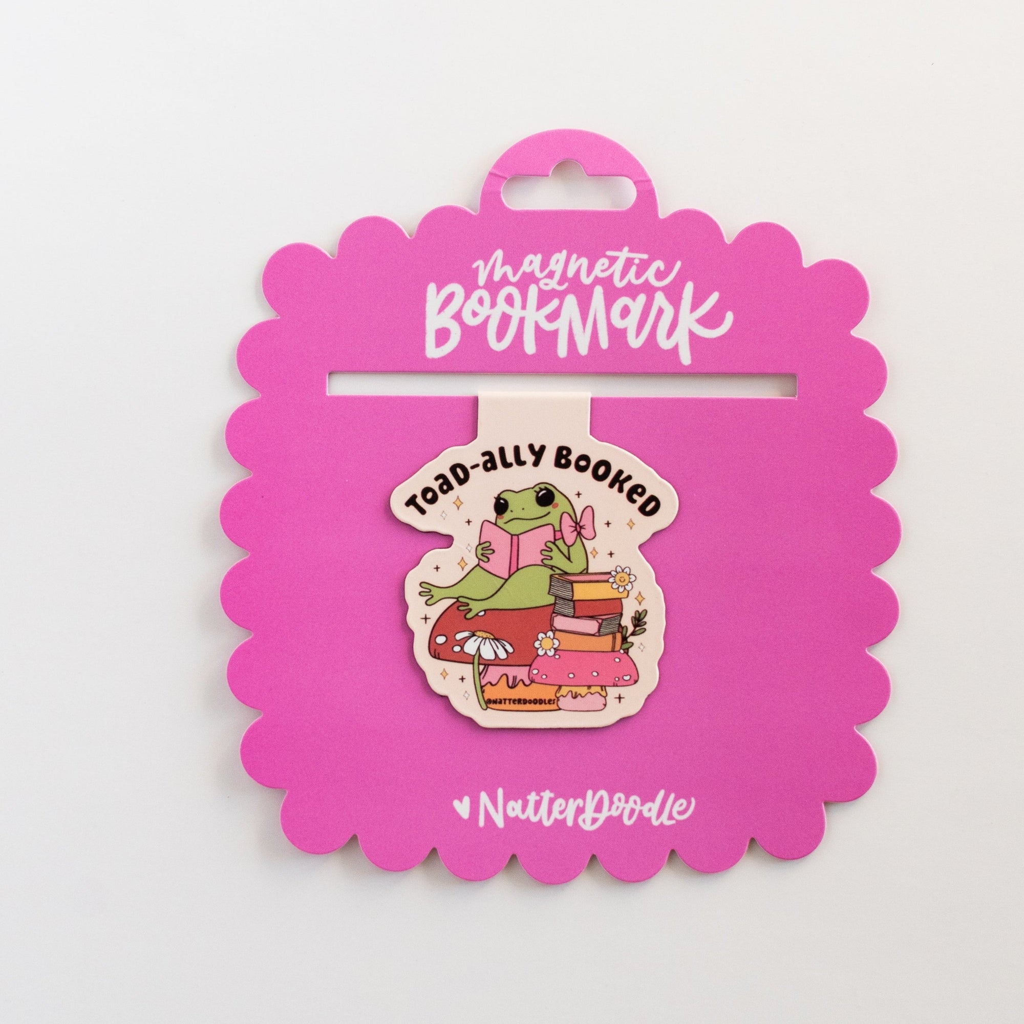 Pink magnetic bookmark with a cartoon character on a white background