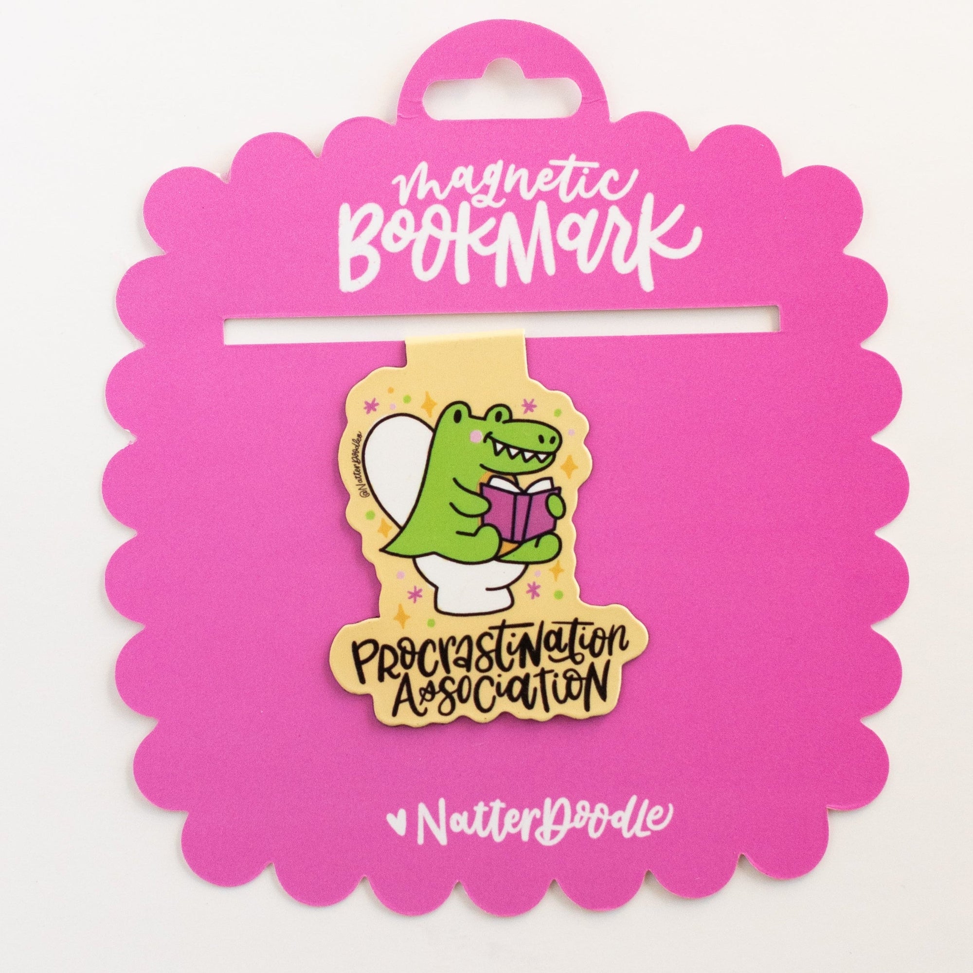 Pink packaging of a magnetic bookmark with a cartoon character on a white background