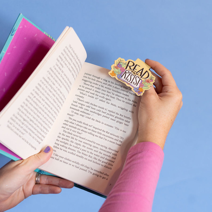 Bookmark with 'Read Resist' text on a pink card against a white background