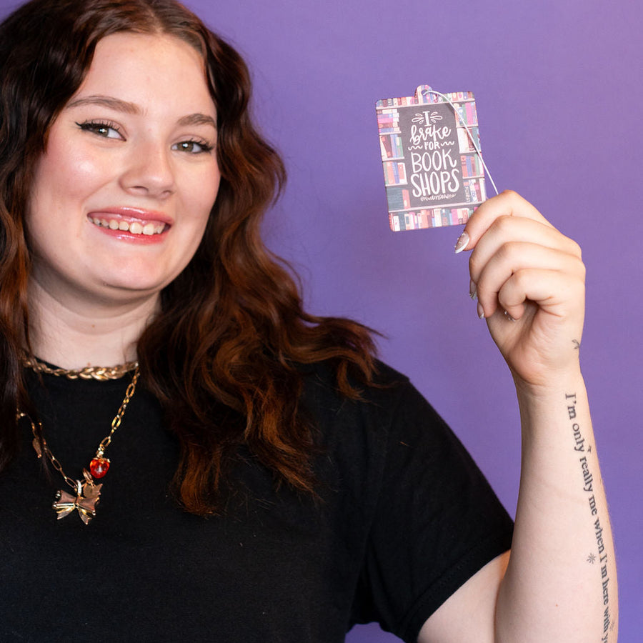 Car air freshener packaging with book-themed design on a white background