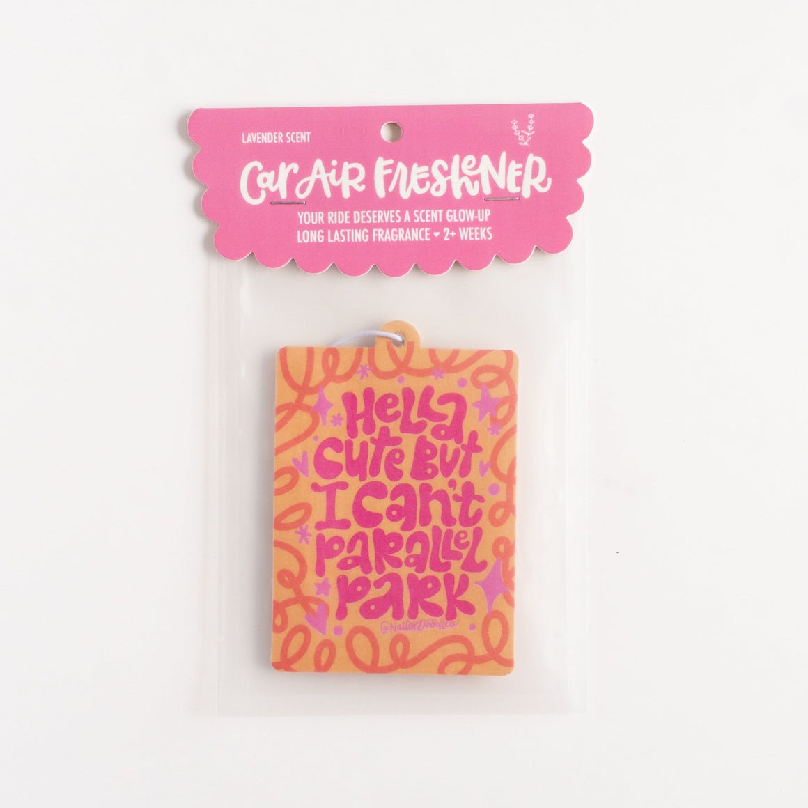 Pink car air freshener with colorful text on a white background