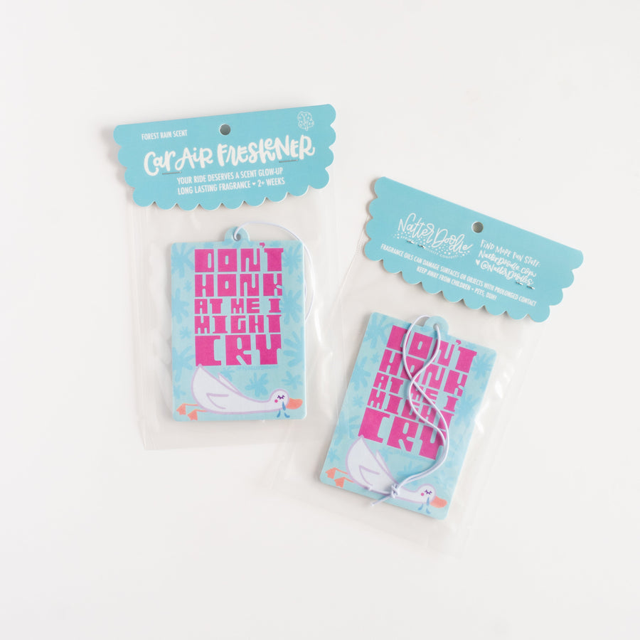 blue car air freshener with packsging featuring a crying goose on a white background