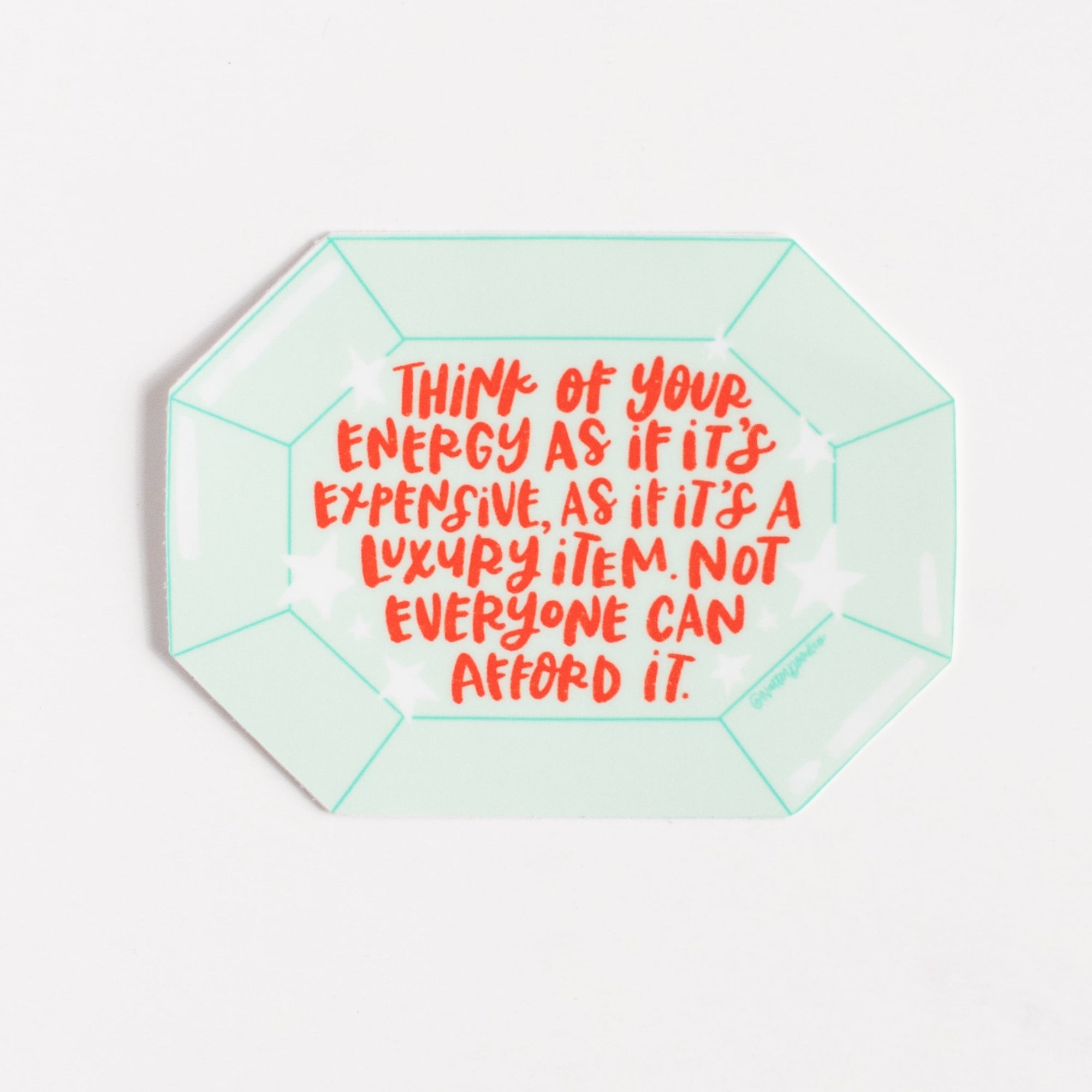 Hexagonal green object with red text on a white background