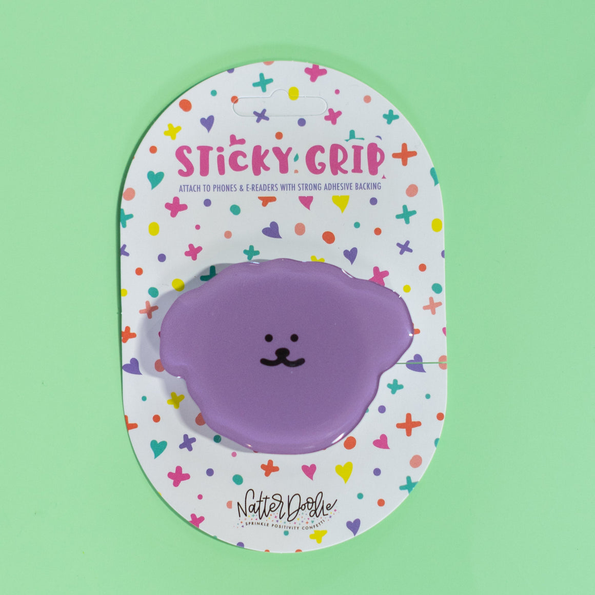 Purple sticky grip with colorful design on a green background