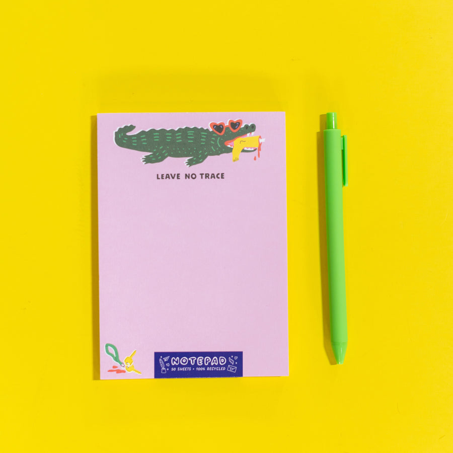 Notepad with a crocodile illustration and 'Leave No Trace' text on a pink background