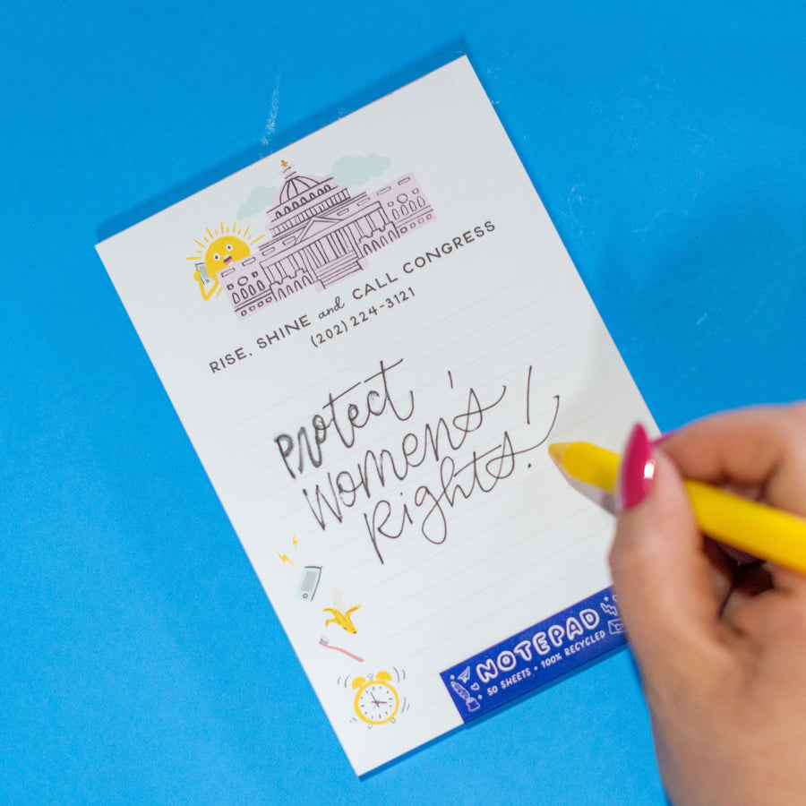 Notepad with a building illustration and text on a white background