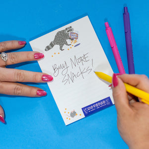 Person holding a small white card with text and graphics on a blue background