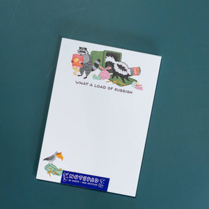 Notebook with cartoon design and text on a teal background