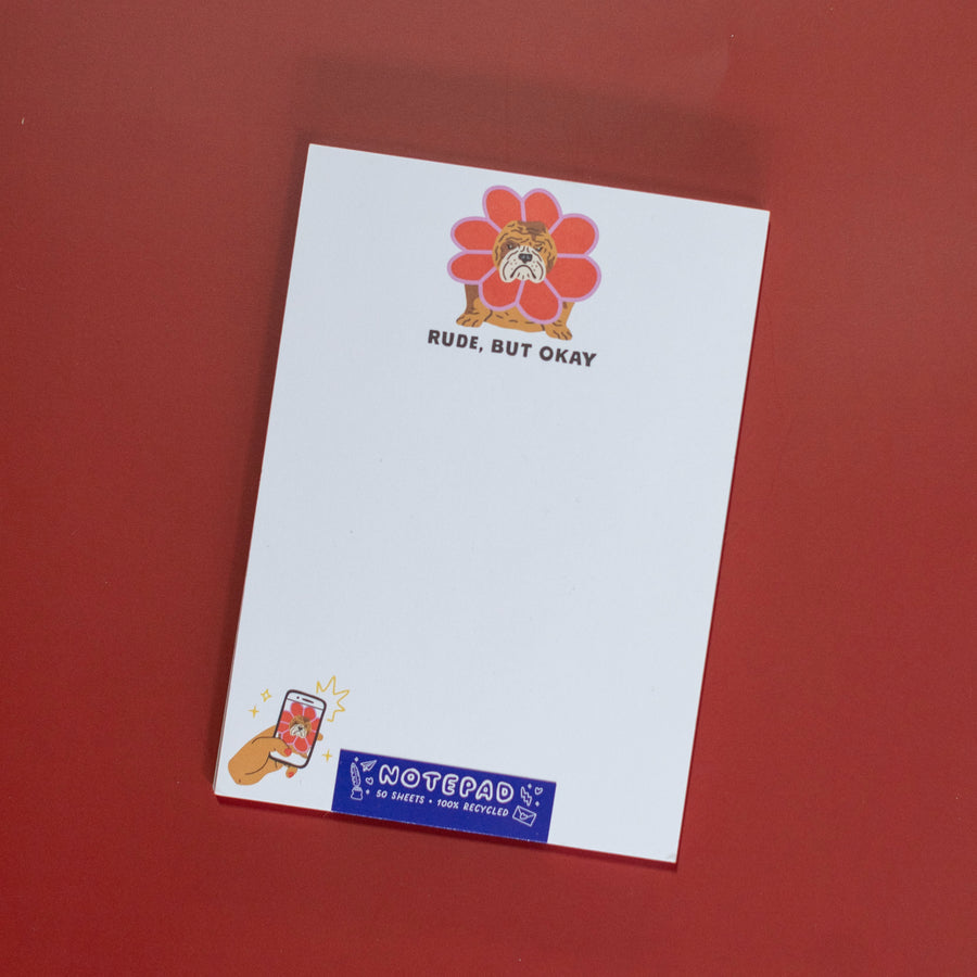 Notepad with a cartoon bulldog on a flower and text 'Rude, But Okay' on a white background