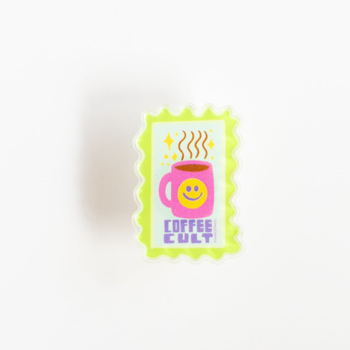 Front view of Coffee Cult glossy acrylic pin with rising steam and sparkles on a soft mint background