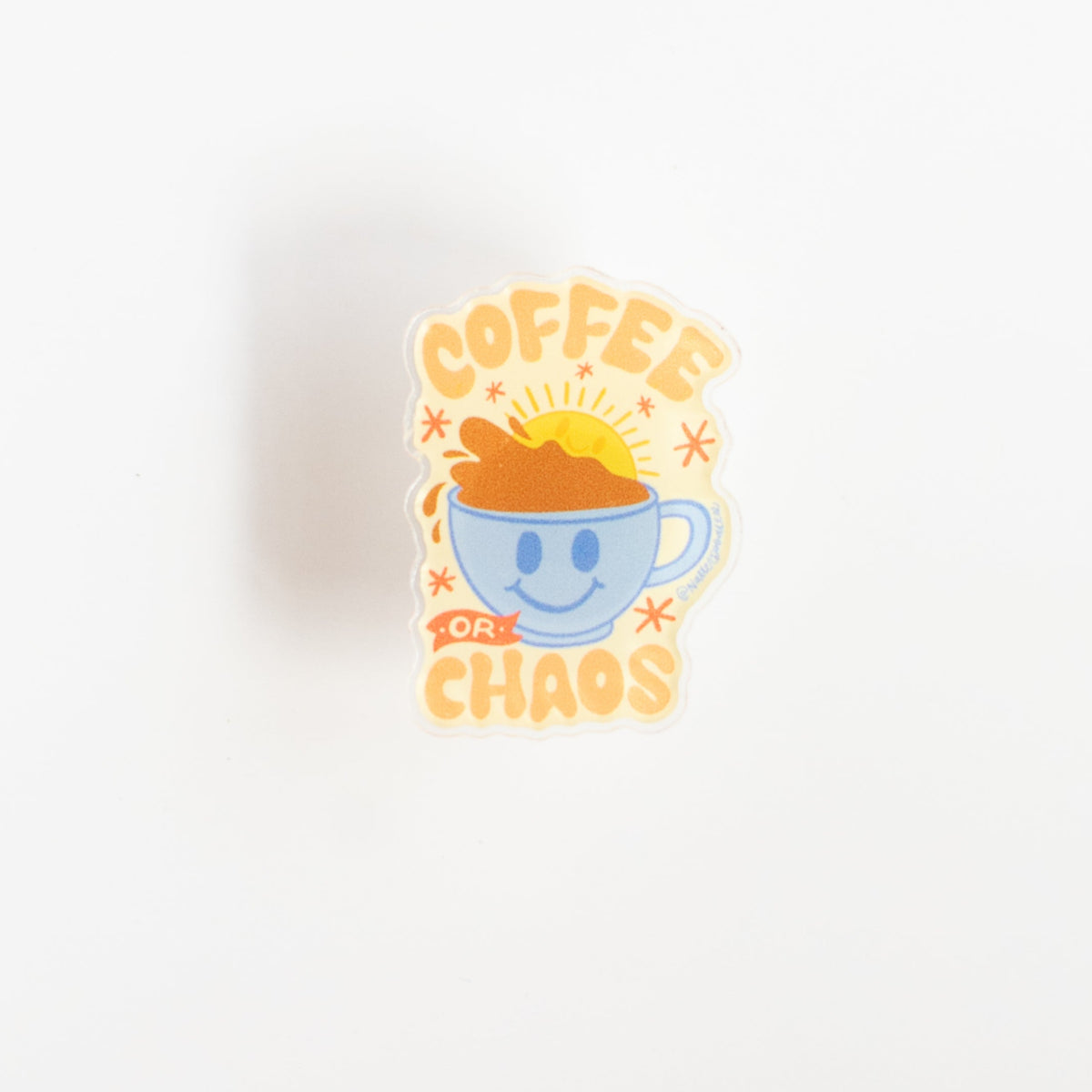 Front view of Coffee or Chaos glossy acrylic pin with orange lettering on a sunny yellow background