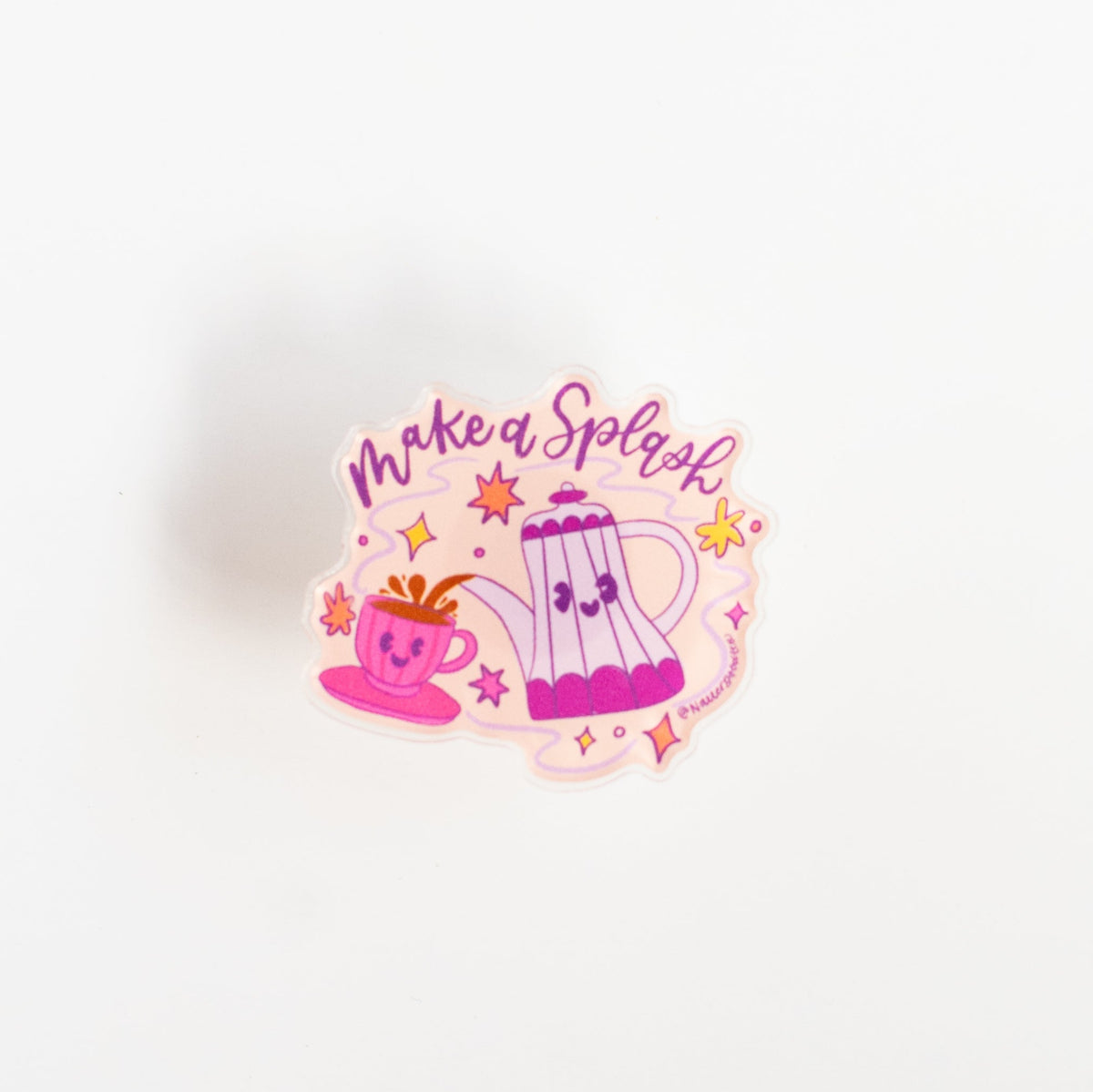 Front view of Make a Splash glossy acrylic pin with purple lettering on a peach background