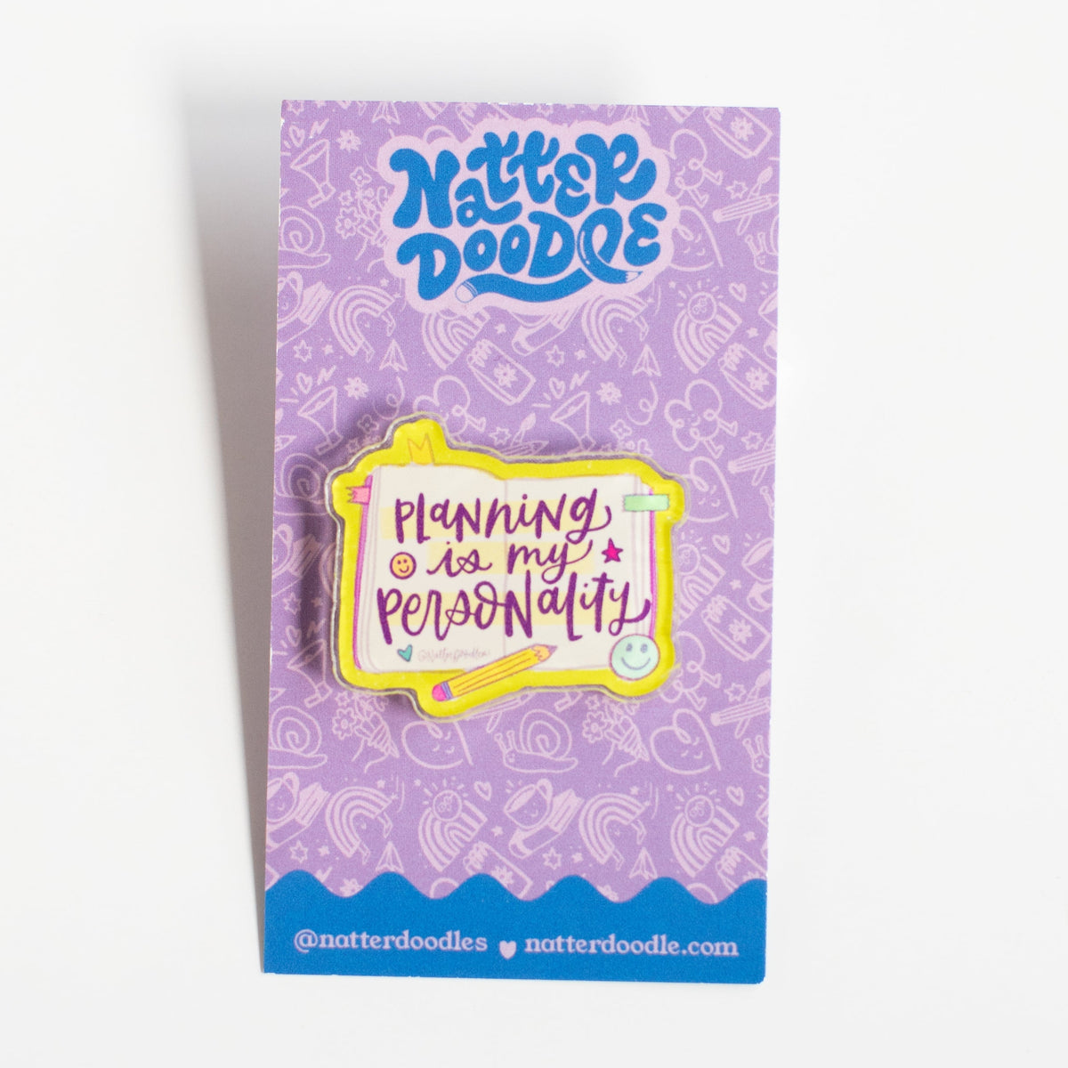 Planning Is My Personality acrylic pin with purple lettering on an open planner design, on a NatterDoodle backing card
