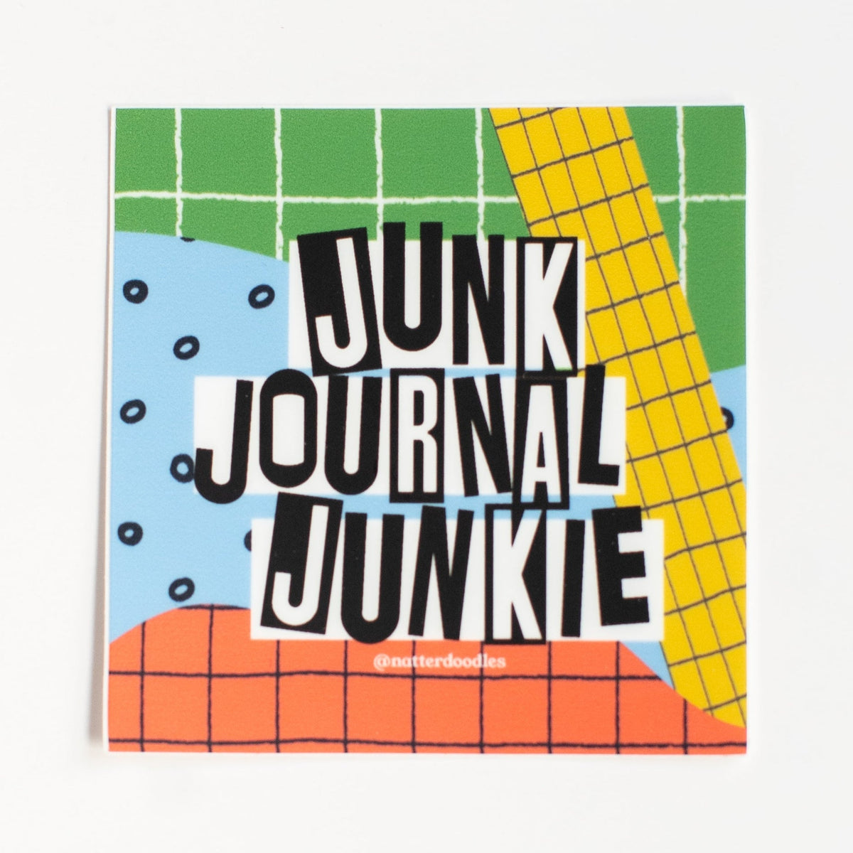 Junk Journal Junkie vinyl sticker with black cut-out lettering on colorful green, yellow, blue and orange grid background