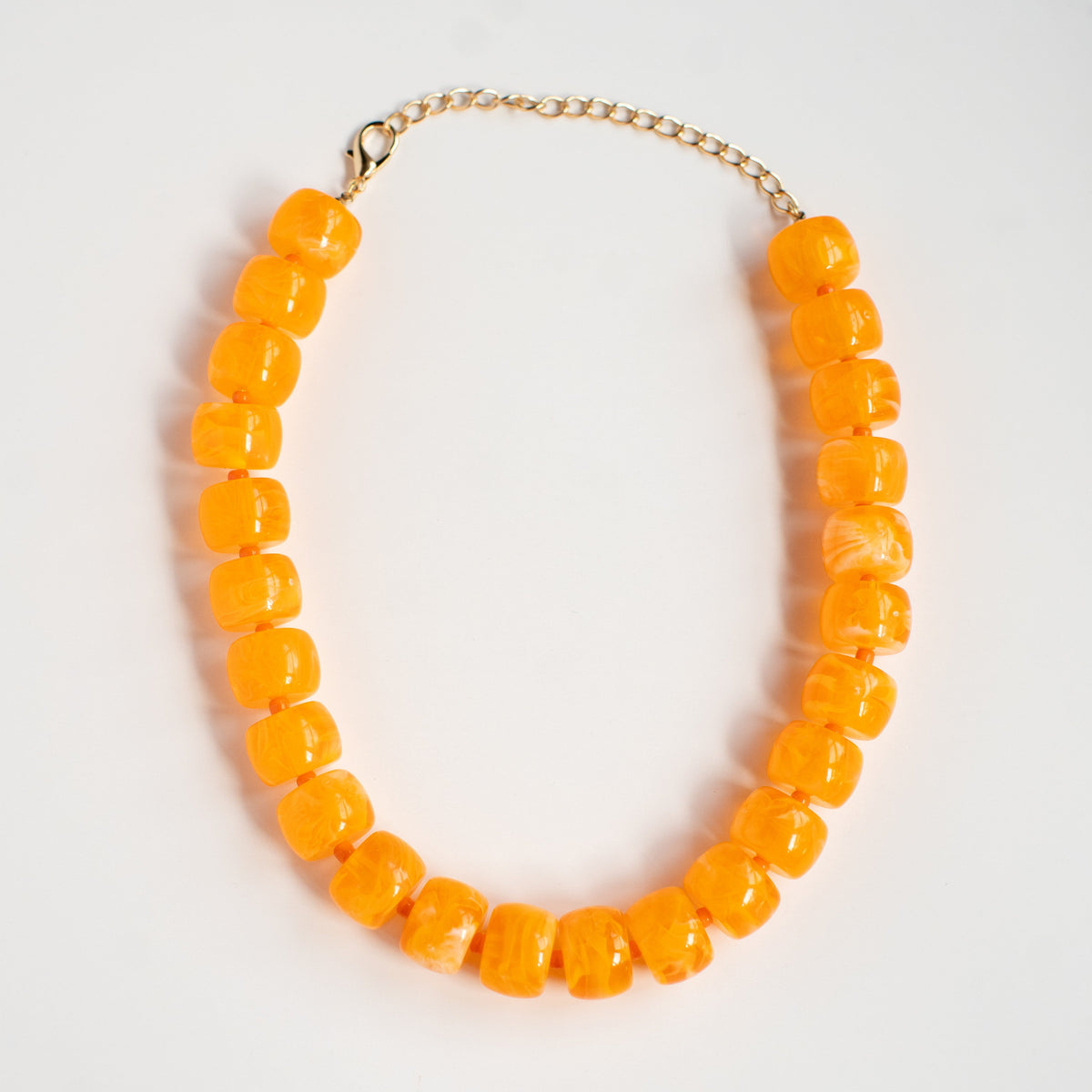 Orange You Glad acrylic beaded necklace by NatterDoodle, front view on a white background