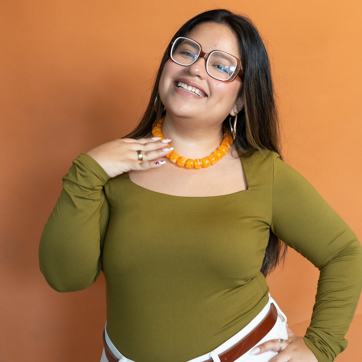 Orange You Glad acrylic beaded necklace held in hand to show scale