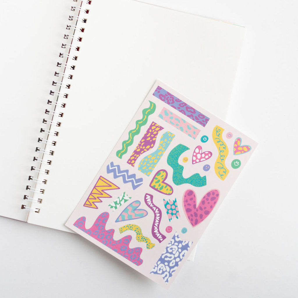 Colorful abstract sticker sheet on a notebook with a white background