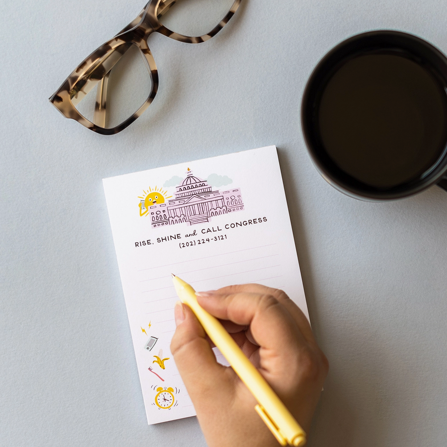Notepad with a building illustration and text on a white background