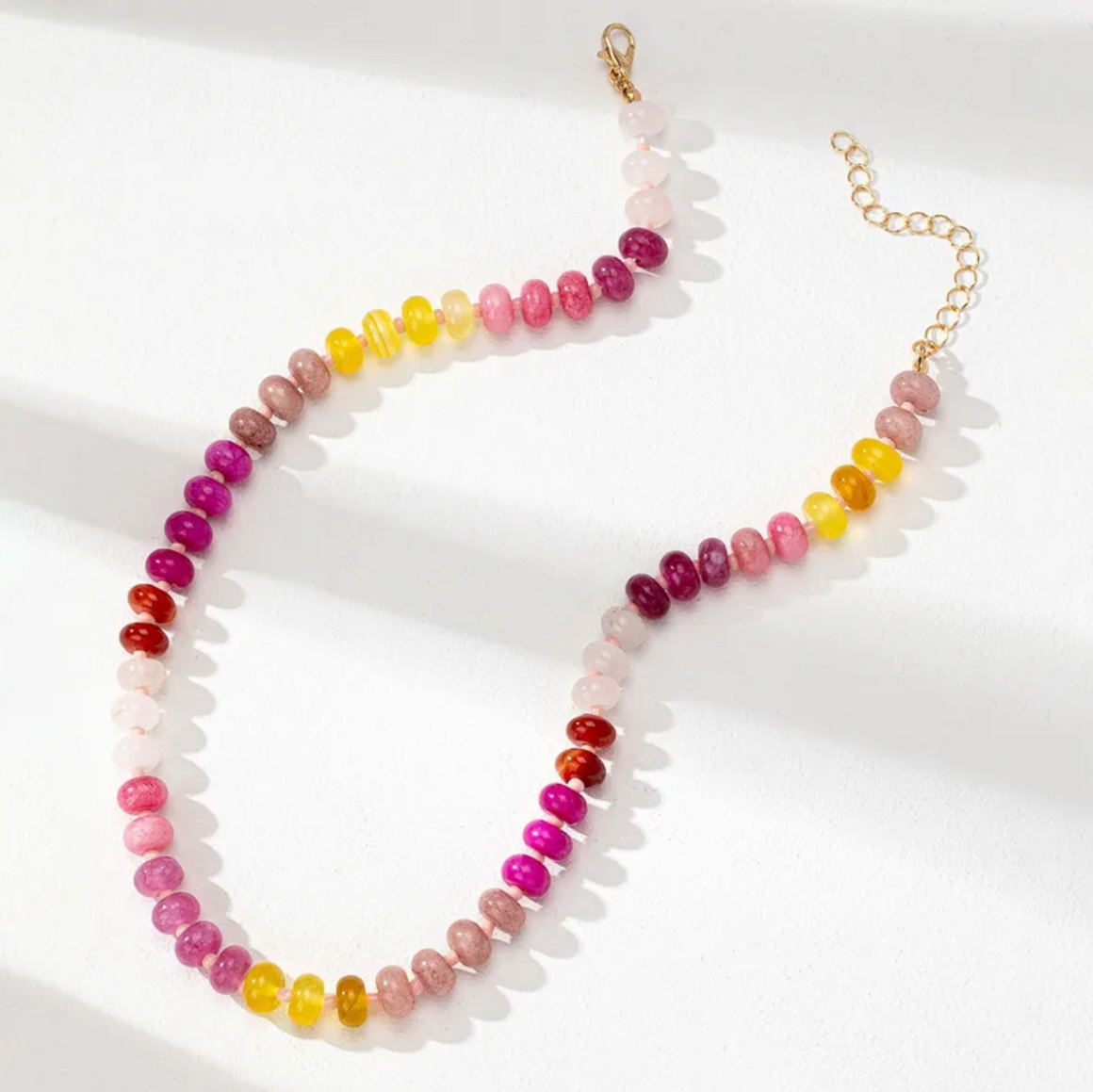 Necklace with multicolored beads on a white background