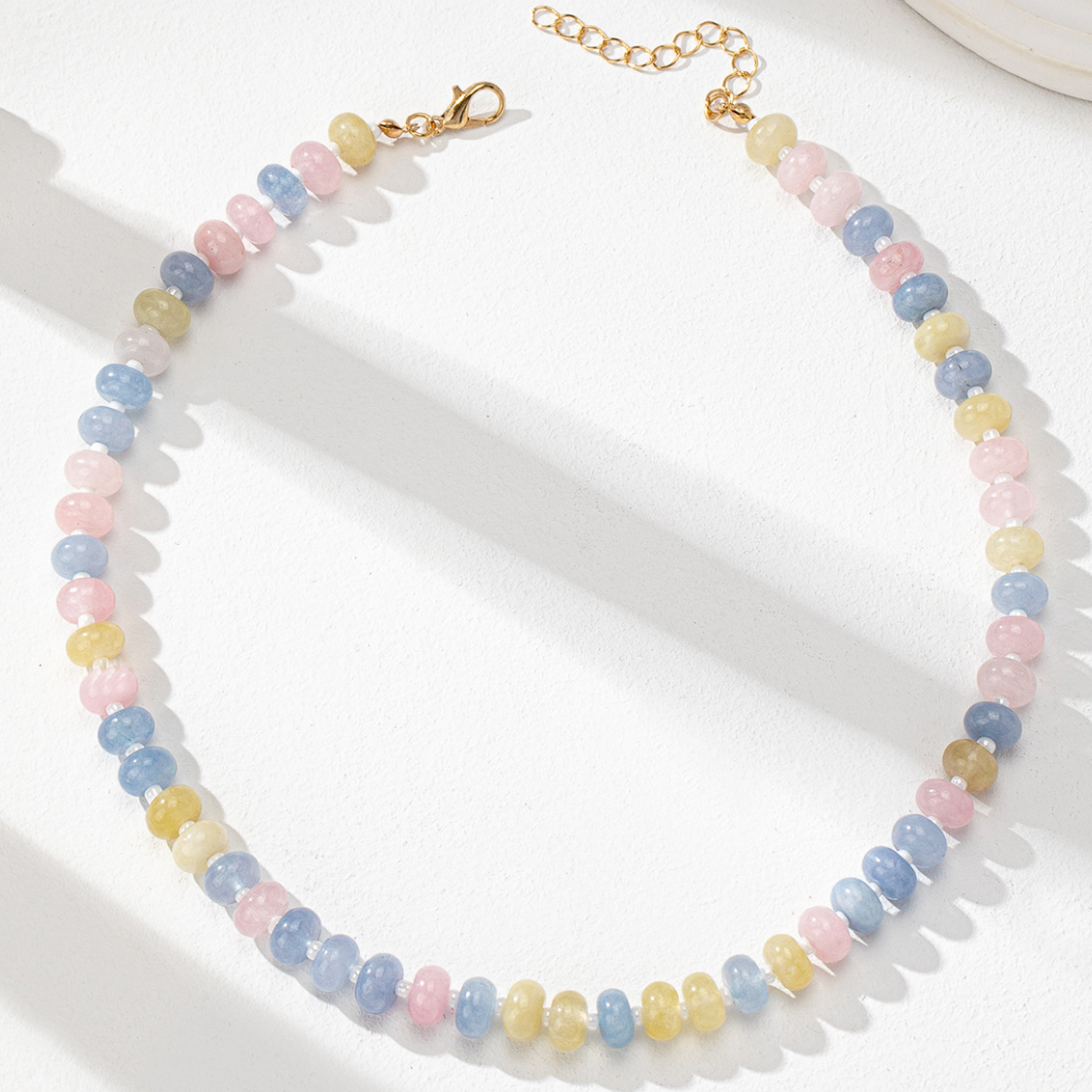 Pastel bead necklace on a white surface
