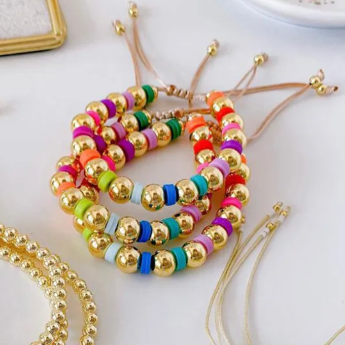 Colorful beaded bracelets on a white surface