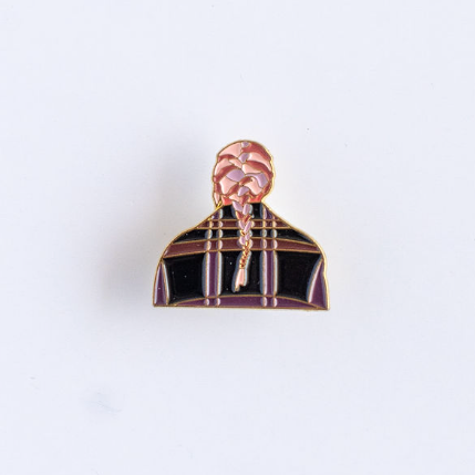 Pin with a design of a person wearing a coat on a white background